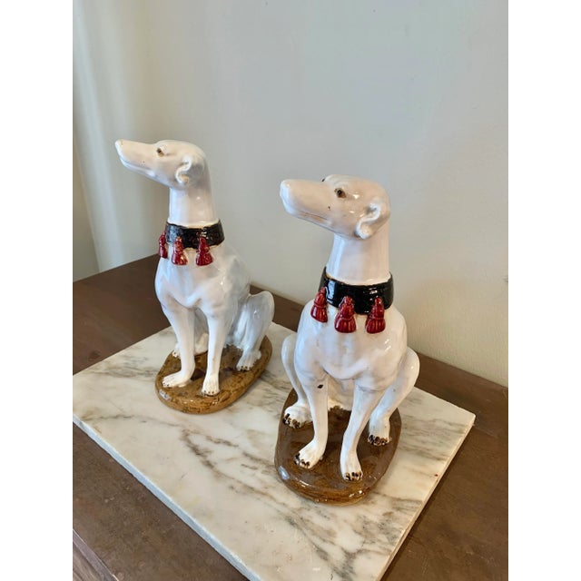 An absolutely stunning pair of Mid 20th Century Italian Ceramic Whippet Sculptures. These pottery whippets are presented...
