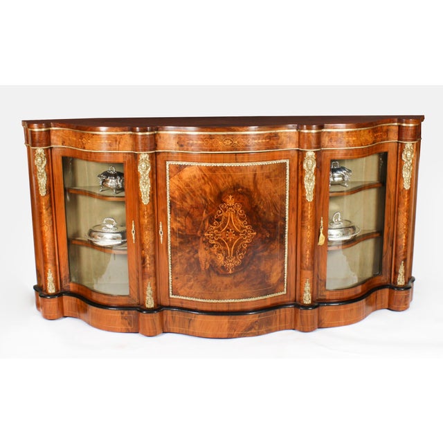 This is an exceptional quality antique Victorian ormolu mounted burr walnut and marquetry inlaid serpentine credenza,...
