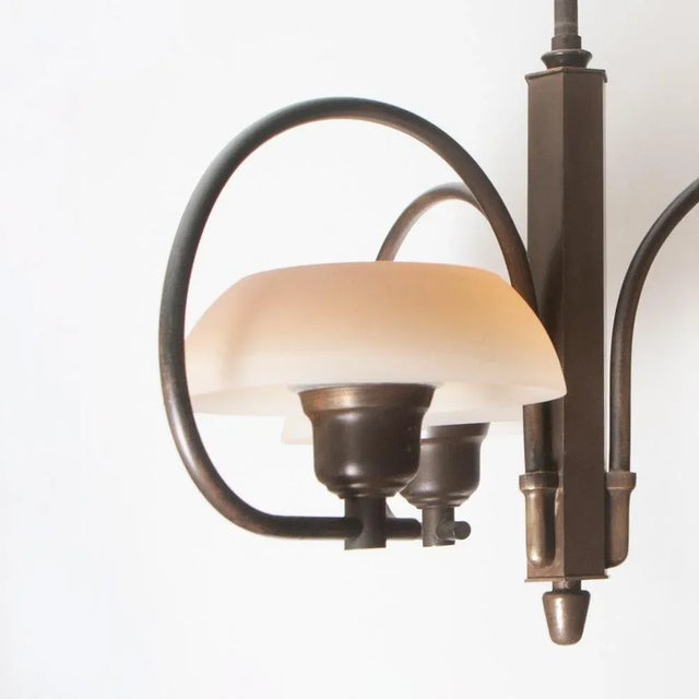 Ceiling lamp by Fog & Mørup. Patinated brass stem and arms, glass shades. Denmark, 1930s. Stem lenght ca 75 cm, width and...