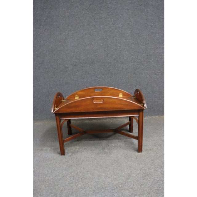 Henkel Harris genuine mahogany butler’s tray coffee table featuring a removable folding tray top with pierced handholds,...