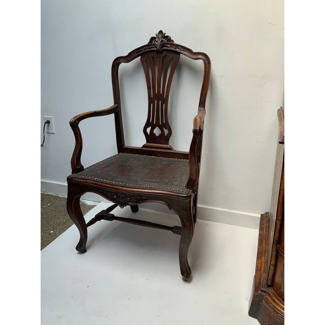 European Carved Walnut Arm Chair. Finely carved Floral Crest and Seat Rail on Cabroile Legs. Original Tooled and Etched...