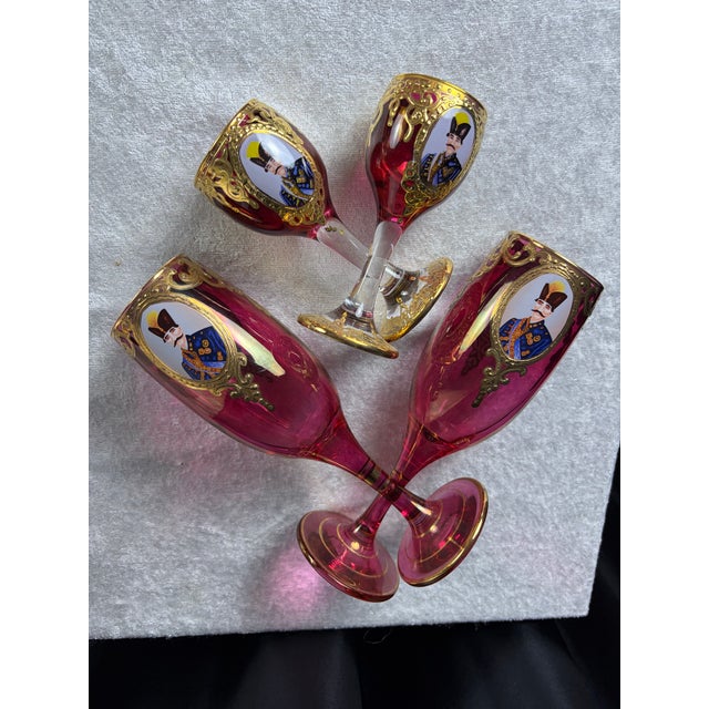 This rare and exquisite 12-piece antique stemware set features hand-blown Bohemian ruby red glass adorned with hand-...