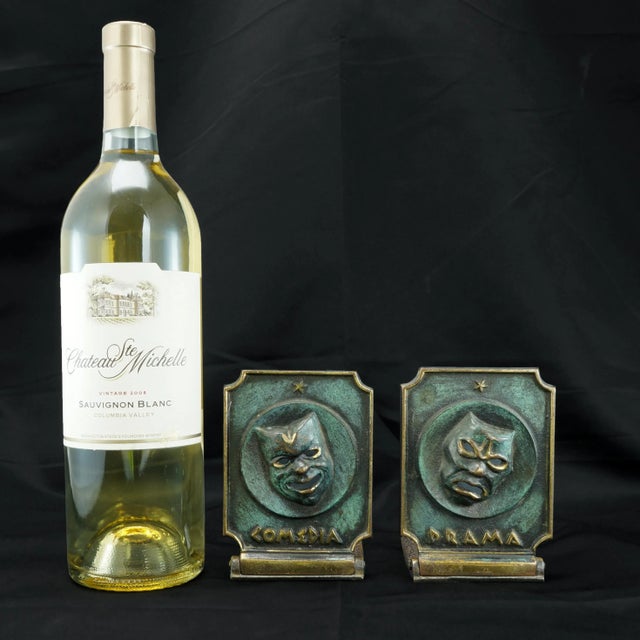 A useful pair of collapsible cast bronze bookends with comedy and drama theater masks. The masks have been given a green...