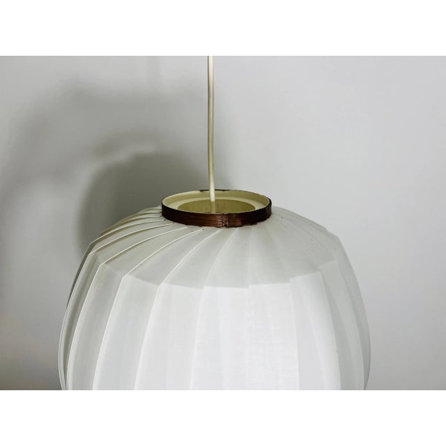 Presenting a pendant lamp from the 1960s, embodying minimalist Italian design with an extravagant and rare design. This...