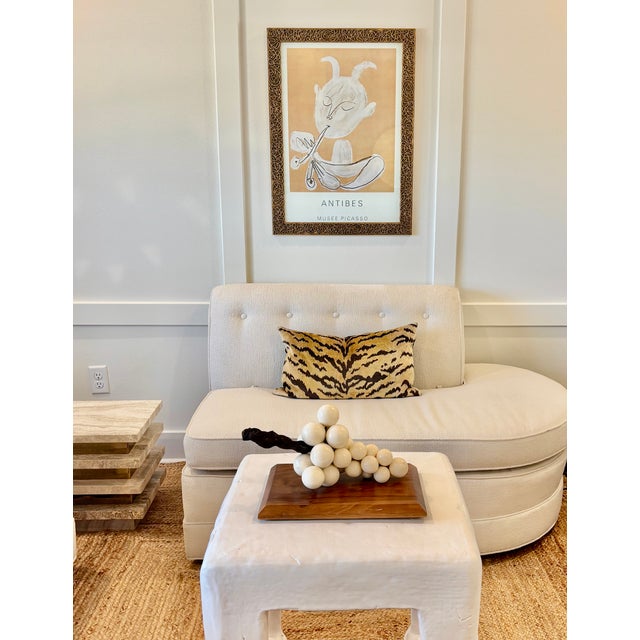 Sculptural grape cluster composed of cream toned grapes with wooden vine mounted on a warm hardwood base. The sculpture is...