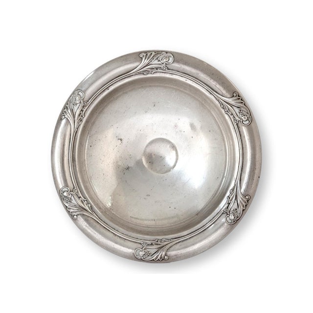 Crafted in the 1940s, this elegant Sterling silver compote features the intricate "Spring Glory" pattern, celebrated for...
