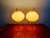 Pair of lamps with a black lacquered metal tripod base and a pale green pleated celluloid shade, 1960s. They are in superb...