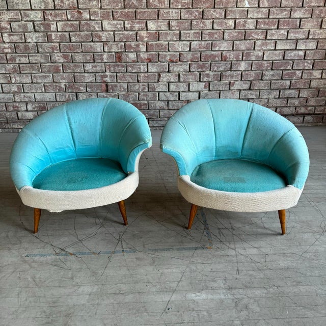 Pair of mid century modern Asymmetrical Shell Chairs. We are unaware of the maker of these chairs. They have a wonderful...