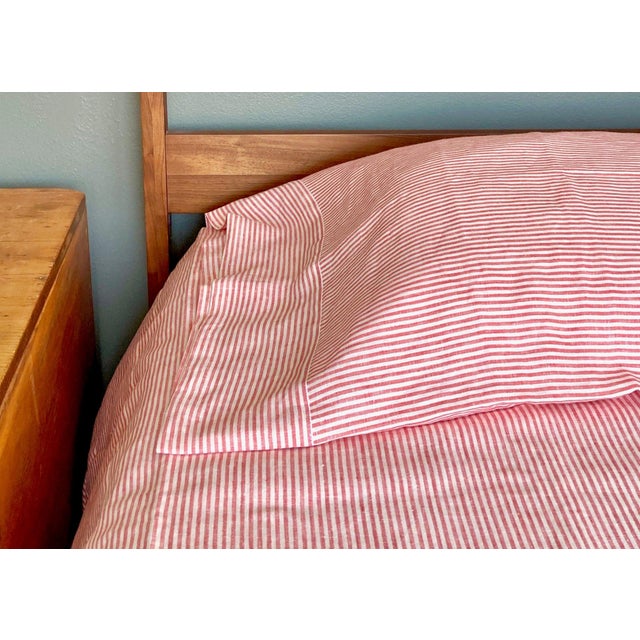 Add a vibrant, playful accent to your space with the Breton Ticking Red collection by Modern Plum Home. This premium 100%...