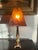 A striking vintage Wescal table lamp featuring a richly patinated metal body paired with a dramatic faux tortoiseshell...