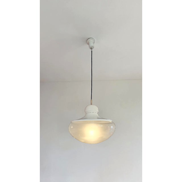 Pendant lamp made in Italy in the 1960s. The chandelier features a white lacquered metal frame and a satin-finish blown...