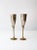 A pair of vintage champagne flutes crafted in brass and silver plate, each featuring a distinctive ribbed chalice form....