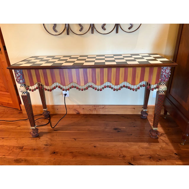 Striking MacKenzie-Childs console table featuring the brand’s signature whimsical combination of hand-painted stripes,...