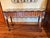 Striking MacKenzie-Childs console table featuring the brand’s signature whimsical combination of hand-painted stripes,...