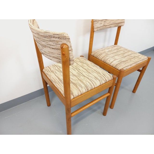 Set of two vintage chairs from the 1970s, by the French manufacturer Baumann, in light golden beech wood, backs and seats...