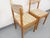 Set of two vintage chairs from the 1970s, by the French manufacturer Baumann, in light golden beech wood, backs and seats...