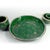 A highly decorative tableware set made of ceramic. All elements are glazed with a high-gloss, deep emerald color. They are...