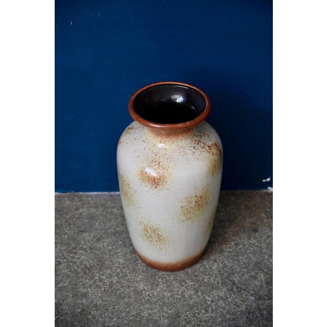 This large German vase from the 1960s has an elongated oval shape and a speckled, nuanced glaze. Placed on the floor or on...