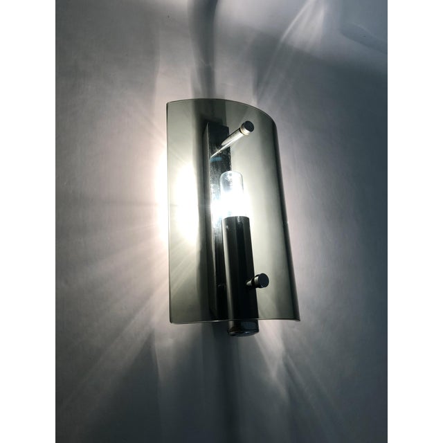 Pair of Italian Veca Fontana Arte style wall sconces in bluish smoked glass and chrome, 1970s Brilliant and transparent,...