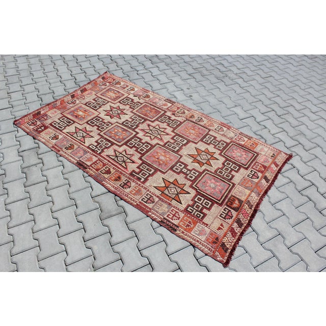This beautiful, traditional vintage, flatweaved Turkish kilim rug is approximately 60 years old. It is handmade of very...