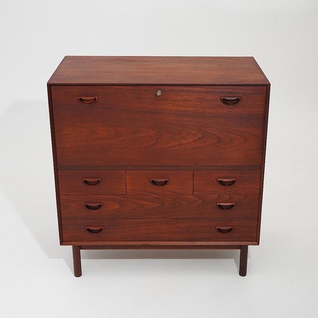 A cabinet that perfectly embodies the principles of Danish design from the 1960s, where formal restraint, material...