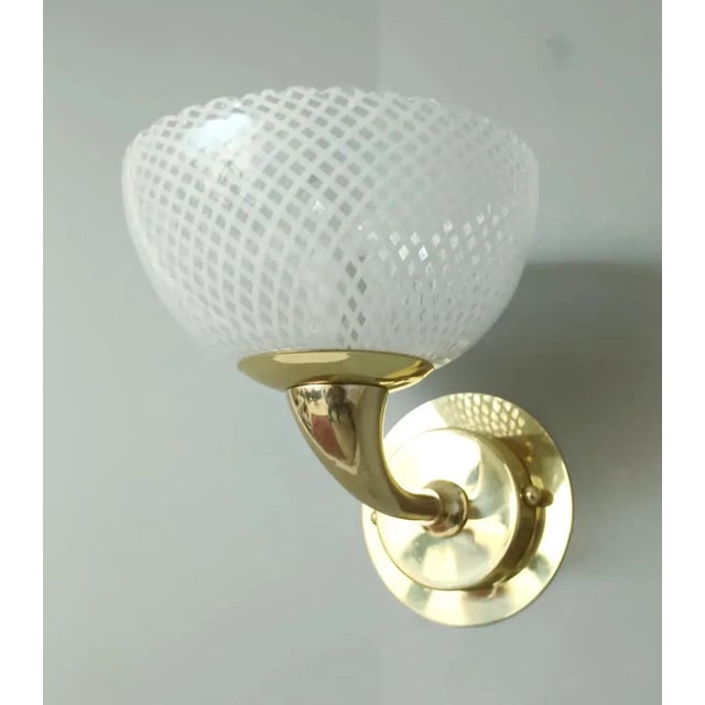 Vintage Italian wall lights with Murano glass cups hand blown in "reticello" technique to form crisscross pattern of white...