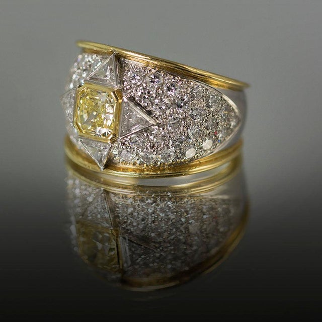Platinum & 18k Ring by Keith Davis, with 1.02 carat GIA certified Fancy Yellow diamond and 4 trillion cut diamonds...