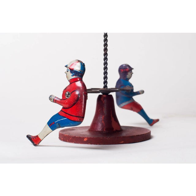 Antique Tin Lithograph Go around spinning toy Early 20th Century It works great Size: 11"H