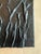 A striking monochromatic abstract panel featuring bold, sculptural ridges that create dramatic movement and shadow....