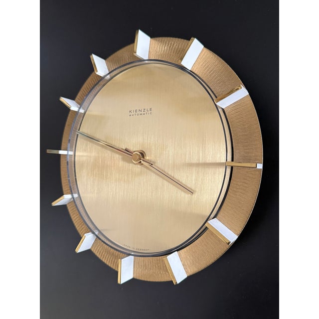 Rare 1960s Kienzle wall clock in brushed brass, Germany. A clean, architectural Mid-Century design with radially brushed...