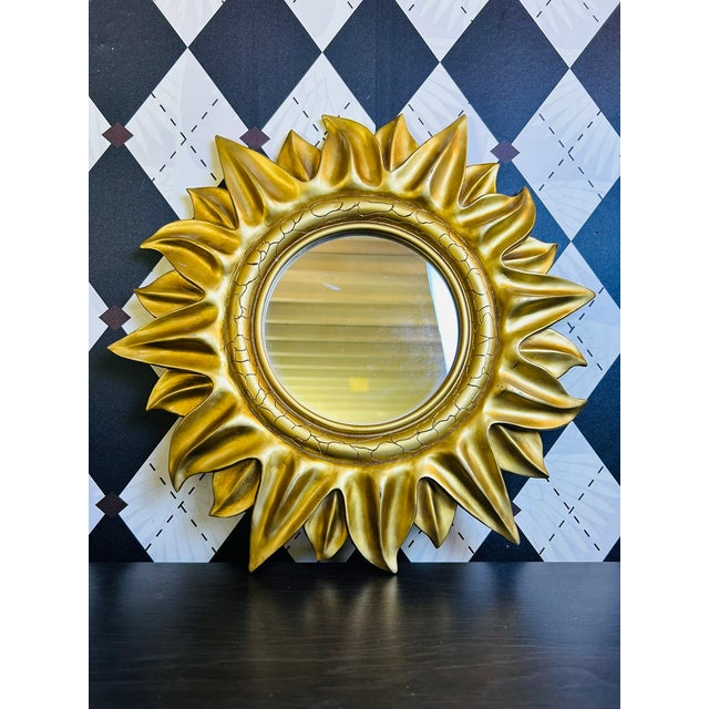 Vintage Hollywood Regency-style sunburst wall mirror with a circular looking glass surrounded by deeply modeled, flame-...