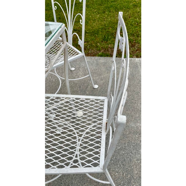 This is an absolutely gorgeous garden or patio table with a glass top and 6 matching chairs with mesh seats, which all...