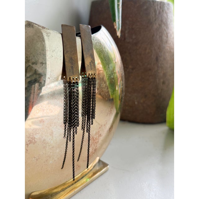 Vintage modernist dangle earrings in a brutalist industrial style, featuring textured brass or bronze rectangular bars...