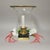 Elegant and substantial, this hurricane lamp features a bell-shaped glass globe with a brass rim, set on a solid black...