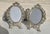 Spelter Metal oval frames with glass faces. Surrounded by floral clusters and climbing vines. Marked on the back: MADE IN...