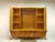 An exceptional living room cabinet from the 1960s with elegant mid-century proportions and a rare, two-part construction....