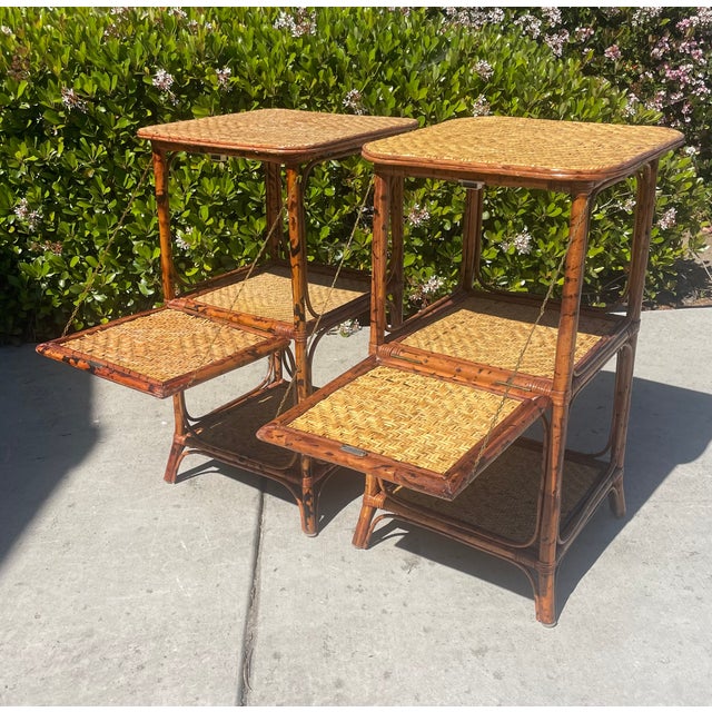 Pair of unique vintage rattan bamboo nightstands with a drop-down shelf. They have an English Victorian aesthetic movement...