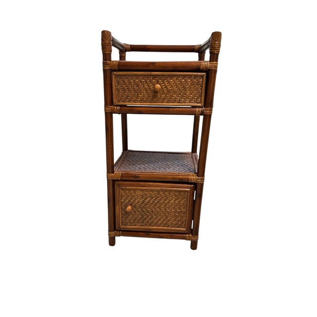 Vintage rattan and bamboo two tier, one drawer, one door with top gallery side / drink table storage cabinet. Measures 15”...