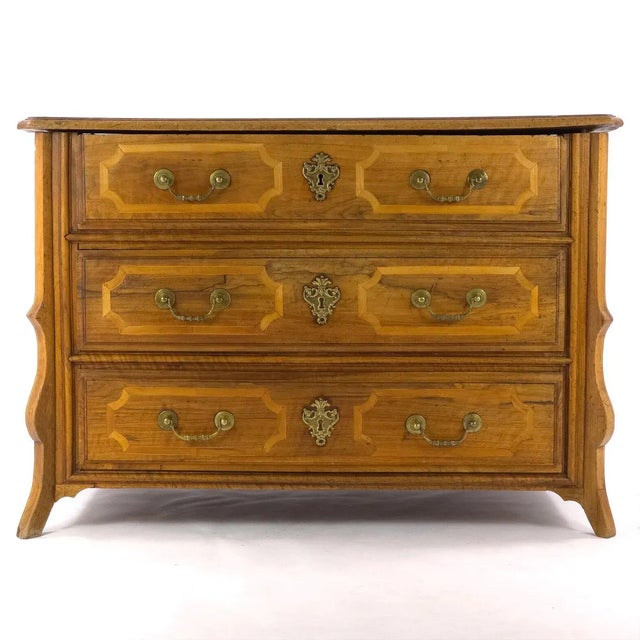 A substantial antique three-drawer commode with the warm, time-softened character of late 18th-century French Provincial...