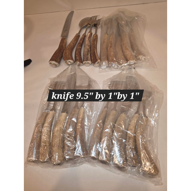 20 total pieces of Antler and Stainless Steel flatware. In new condition most of it still wrapped up...the knife has a...
