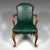 This is an antique clerk's desk chair. An English, beech and leather elbow seat, dating to the early 20th century, circa...