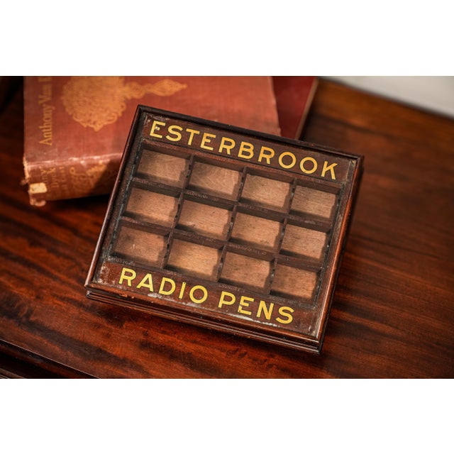 This scarce and highly collectible Esterbrook Radio Pens antique advertising retail display case, dating to around 1915,...