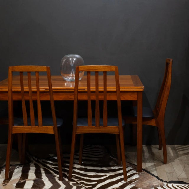 ABOUT A set of four high back, two tone dining chairs with a solid Teak frame. Reupholstered recently in a textured faux...