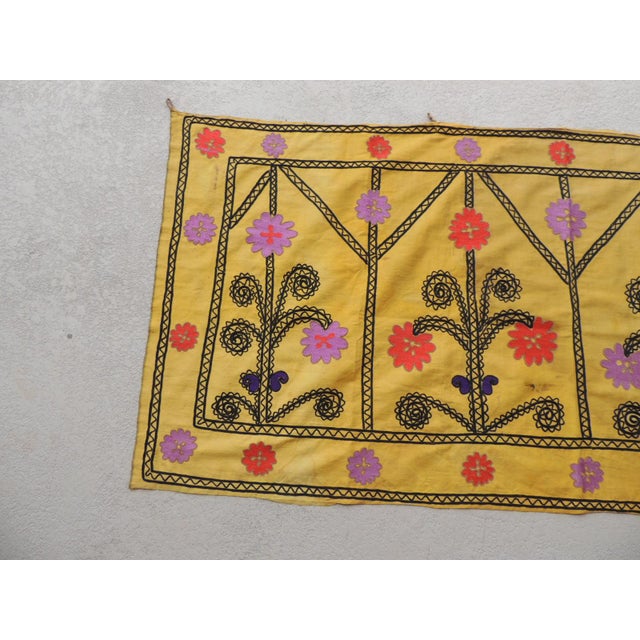 Vintage yellow and black embroidery Suzani textile panel. Depicting flowers and trellis pattern. Silk on silk embroidery....