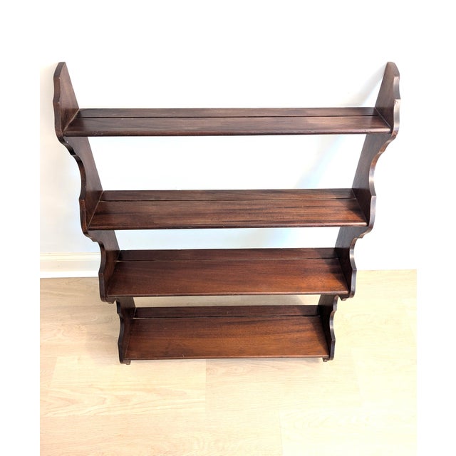 The style of this lovely mahogany antique hanging wall shelf is often described as "whale-end" or "waterfall" due to the...