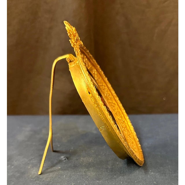 This Continental late 19th century painting bears the KPM blue scepter mark on the back of the oval porcelain. A young...