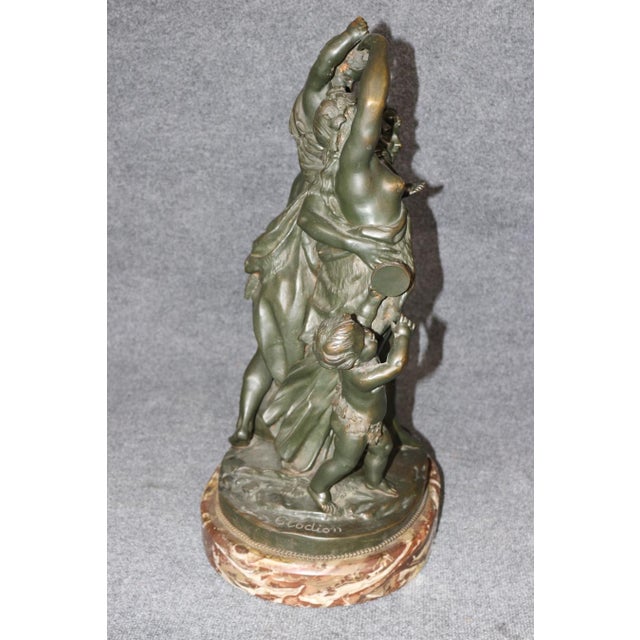 An exceptionally beautiful and richly detailed antique bronze sculpture depicting a lively classical Bacchanalian...
