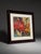 Bold colorful floral abstract artwork featuring bright red, orange, yellow, green, blue, and cream tones. The piece has a...