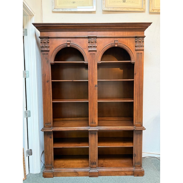 Design Plus Gallery presents a Double Arch Display Cabinet from Pioneer Furniture Company. The cabinet his Corinthian...