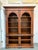 Design Plus Gallery presents a Double Arch Display Cabinet from Pioneer Furniture Company. The cabinet his Corinthian...